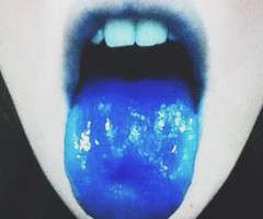 A girl's tongue and lips are colored blue from taking liquid methylene, a nootropic.