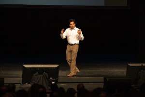 Author Sal Khan speaks on stake at a public conference.